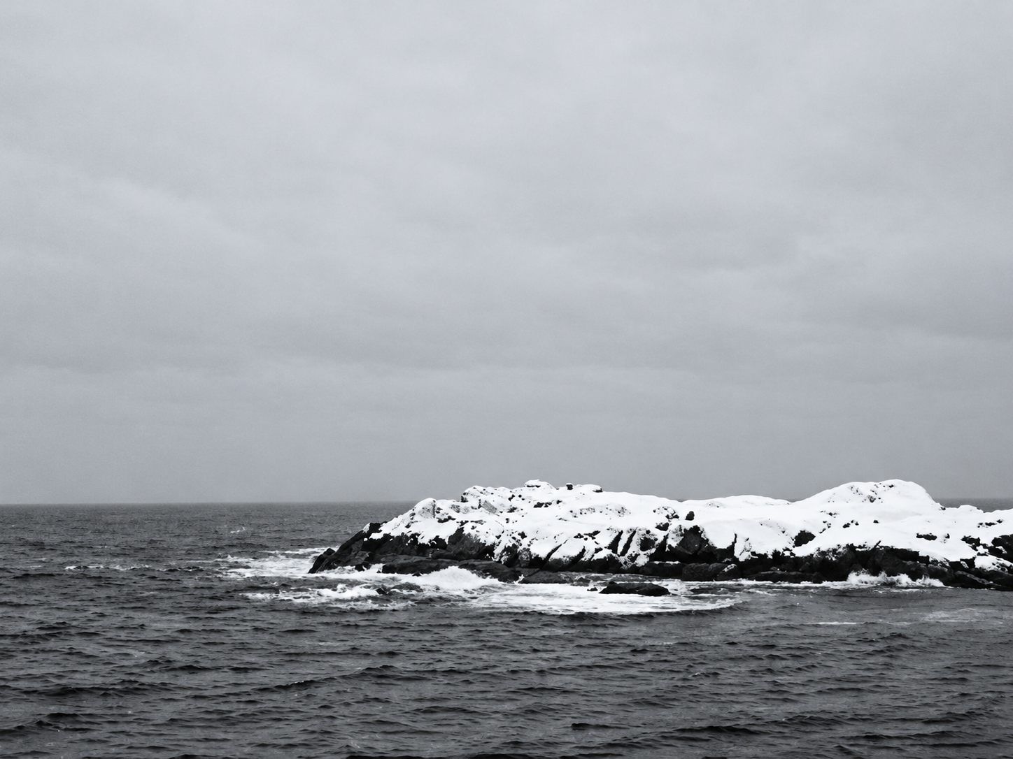 Snowy coastline bordering the sea